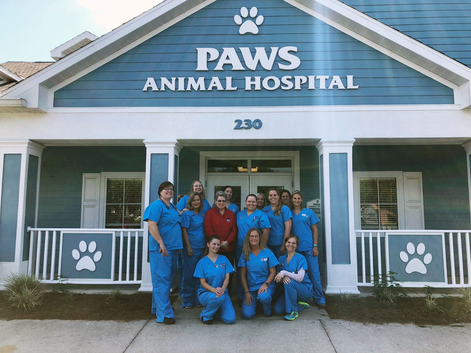 The Paws Animal Hospital Building with staff members